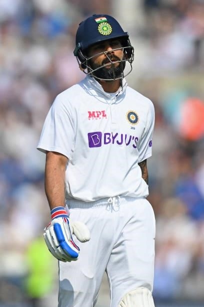 India's captain Virat Kohli reacts as he walks back to the pavilion after losing his wicket for 44 runs during play on the fourth day of the fourth...