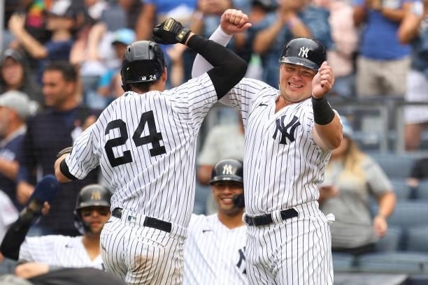 Gary Sanchez of the New York Yankees celebrates with Luke Voit after hitting a grand slam home run against the Baltimore Orioles during the second...