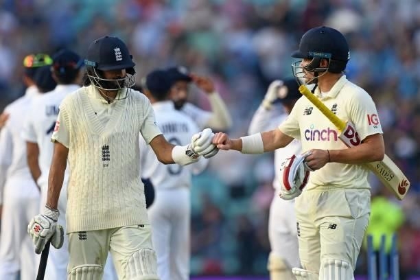 England's Haseeb Hameed and England's Rory Burns gesture during their opening stand during play on the fourth day of the fourth cricket Test match...