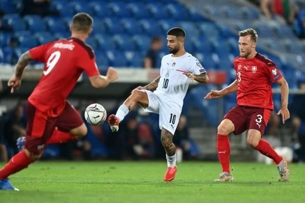 Italy's midfielder Lorenzo Insigne controls the ball next to Switzerland's defender Silvan Widmer during the World Cup 2022 qualifier football match...