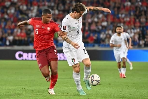 Switzerland's defender Manuel Akanji vies with Italy's midfielder Nicolo Zaniolo during the World Cup 2022 qualifier football match between...
