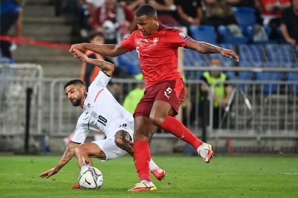 Italy's midfielder Lorenzo Insigne vies with Switzerland's defender Manuel Akanji during the World Cup 2022 qualifier football match between...