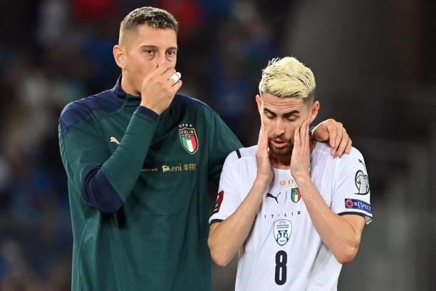 Italy's goalkeeper Pierluigi Gollini and Italy's midfielder Jorginho react at the end of the World Cup 2022 qualifier football match between...