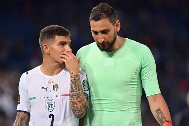 Italy's defender Giovanni Di Lorenzo speaks with Italy's goalkeeper Gianluigi Donnarumma at the end of the World Cup 2022 qualifier football match...