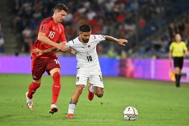 Switzerland's midfielder Christian Fassnacht vies with Italy's midfielder Lorenzo Insigne during the World Cup 2022 qualifier football match between...