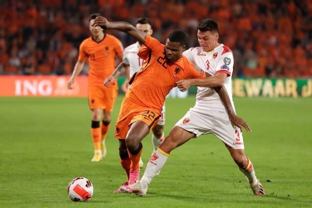 Denzel Dumfries of Holland, Risto Radunovic of Montenegro during the World Cup Qualifier match between Holland v Montenegro at the Philips Stadium on...