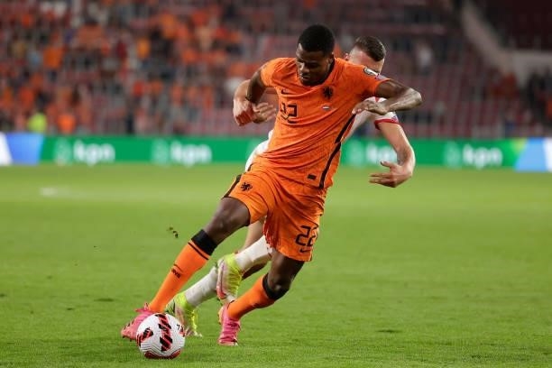 Milutin Osmajic of Montenegro. Denzel Dumfries of Holland during the World Cup Qualifier match between Holland v Montenegro at the Philips Stadium on...
