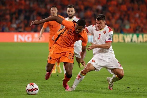 Denzel Dumfries of Holland, Risto Radunovic of Montenegro during the World Cup Qualifier match between Holland v Montenegro at the Philips Stadium on...