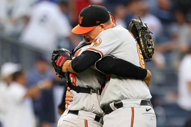 Closing pitcher Tyler Wells of the Baltimore Orioles is hugged by catcher Pedro Severino after getting the final out to defeat the New York Yankees...
