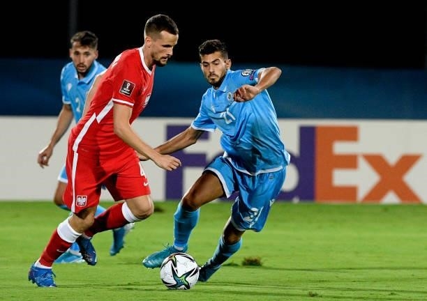 Tomasz Kedziora of Poland competes for the ball with Lorenzo Lunadei of San Marino ,during the 2022 FIFA World Cup Qualifier match between San Marino...