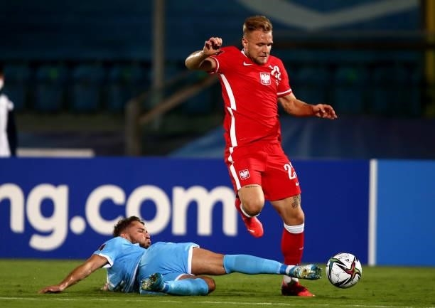 Tymoteusz Puchacz of Poland competes for the ball with Alessandro D'Addario of San Marino ,during the 2022 FIFA World Cup Qualifier match between San...