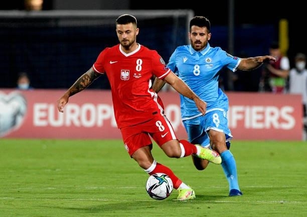 Karol Linetty of Poland competes for the ball with Enrico Golinucci of San Marino ,during the 2022 FIFA World Cup Qualifier match between San Marino...