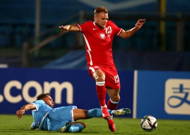 Tymoteusz Puchacz of Poland competes for the ball with Alessandro D'Addario of San Marino ,during the 2022 FIFA World Cup Qualifier match between San...