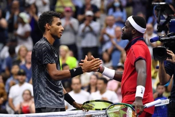 Canada's Felix Auger-Aliassime shakes hands with USA's Frances Tiafoe after winning their 2021 US Open Tennis tournament men's singles fourth round...