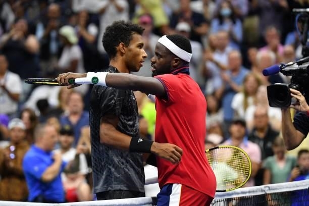 Canada's Felix Auger-Aliassime hugs USA's Frances Tiafoe after winning their 2021 US Open Tennis tournament men's singles fourth round match at the...