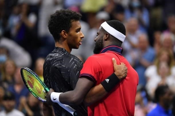 Canada's Felix Auger-Aliassime hugs USA's Frances Tiafoe after winning their 2021 US Open Tennis tournament men's singles fourth round match at the...