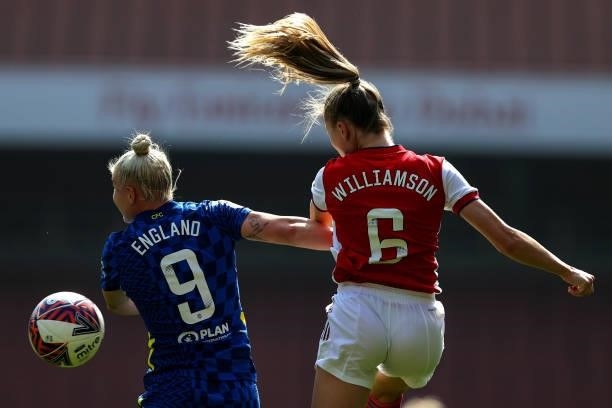 The hair of Leah Williamson is backlit as she goes up for a header with Bethany England of Chelsea during the Barclays FA Women's Super League match...