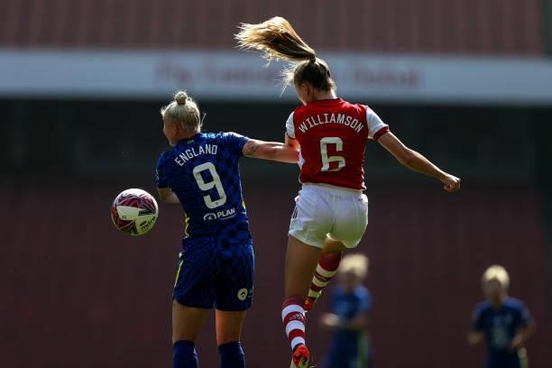 The hair of Leah Williamson is backlit as she goes up for a header with Bethany England of Chelsea during the Barclays FA Women's Super League match...