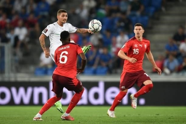 Italy's midfielder Marco Verratti controls the ball next to Switzerland's midfielder Denis Zakaria and Switzerland's midfielder Christian Fassnacht...
