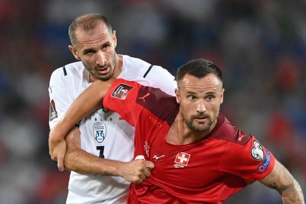 Italy's defender Giorgio Chiellini fights for the ball with Switzerland's forward Haris Seferovic during the World Cup 2022 qualifier football match...