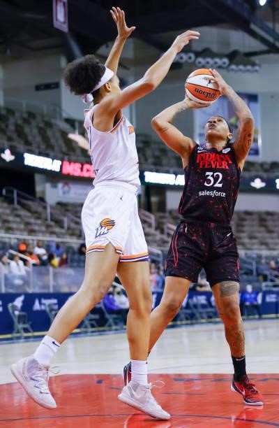 Emma Cannon of the Indiana Fever shoots the ball against Megan Walker of the Phoenix Mercury during the game at Indiana Farmers Coliseum on September...
