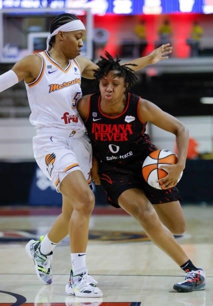 Kelsey Mitchell of the Indiana Fever dribbesl the ball against Shey Peddy of the Phoenix Mercury at Indiana Farmers Coliseum on September 4, 2021 in...