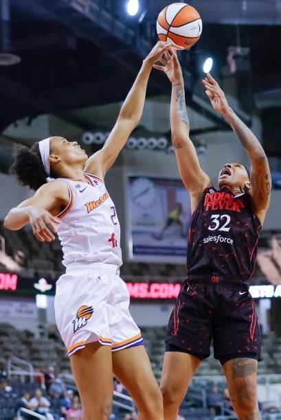 Emma Cannon of the Indiana Fever shoots the ball against Megan Walker of the Phoenix Mercury during the game at Indiana Farmers Coliseum on September...