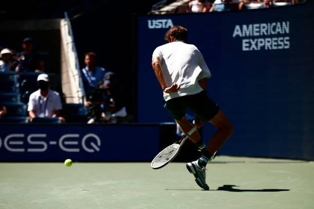 Russia's Daniil Medvedev hits a between-the-legs shot as he returns the ball to Netherlands' Botic van de Zandschulp during their 2021 US Open Tennis...