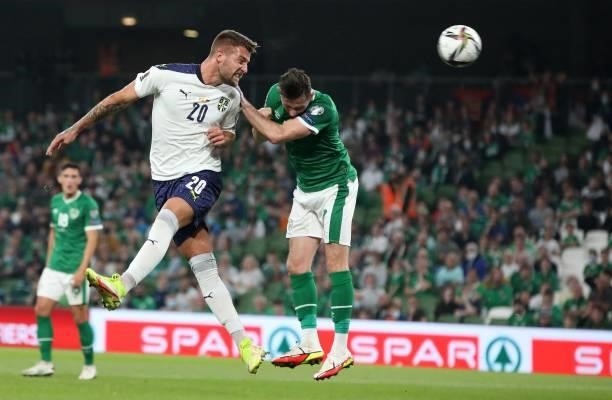 Serbia's midfielder Sergej Milinkovic-Savic heads the ball past Republic of Ireland's midfielder Alan Browne to score the opening goal during the...