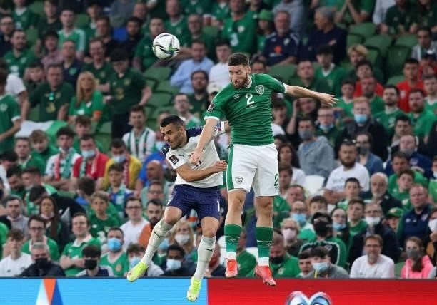 Serbia's midfielder Filip Kostic vies to header the ball with Republic of Ireland's defender Matt Doherty during the FIFA World Cup Qatar 2022...