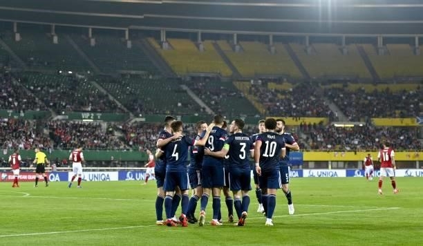 Scotland's forward Lyndon Dykes celebrates scoring the opening goal from the penalty spot with his teammates during the FIFA World Cup Qatar 2022...