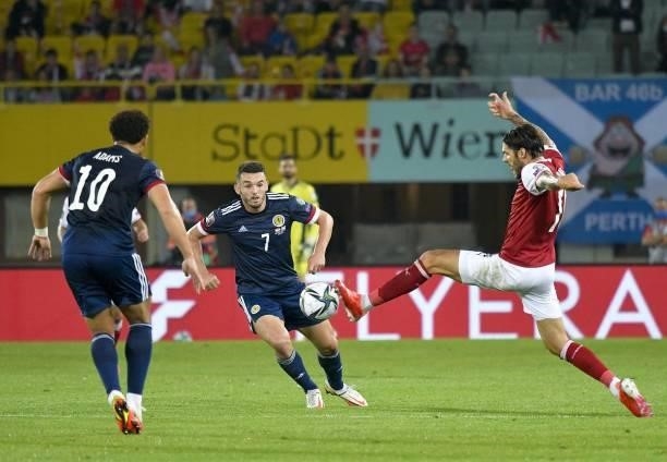 Austria's defender Christopher Trimmel and Scotland's midfielder John McGinn vie for the ball during the FIFA World Cup Qatar 2022 qualification...
