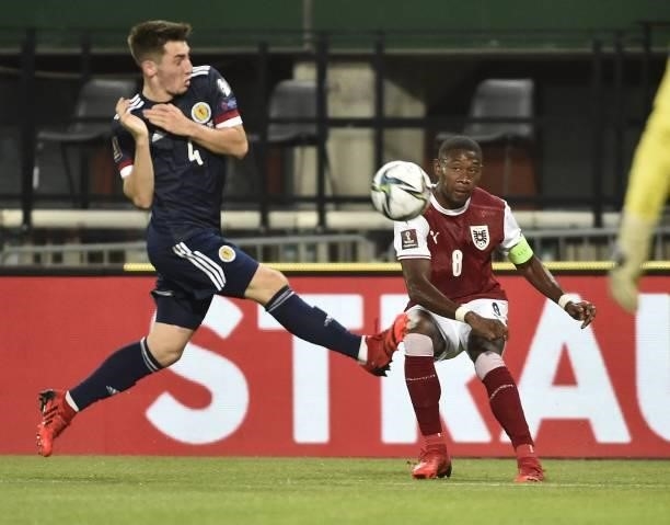 Austria's defender David Alaba and Scotland's midfielder Billy Gilmour vie for the ball during the FIFA World Cup Qatar 2022 qualification Group F...