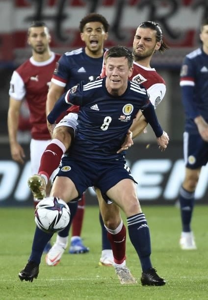 Austria's midfielder Florian Grillitsch and Scotland's midfielder Callum McGregor vie for the ball during the FIFA World Cup Qatar 2022 qualification...