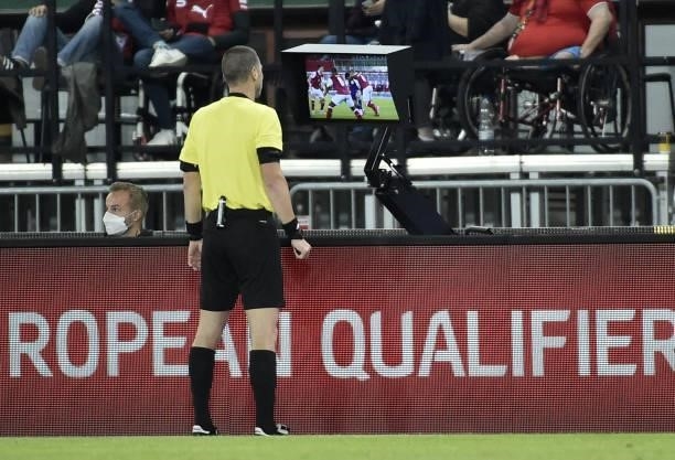 Referee Georgi Kabakov checks the VAR monitor before awarding a penalty to Scotland during the FIFA World Cup Qatar 2022 qualification Group F...