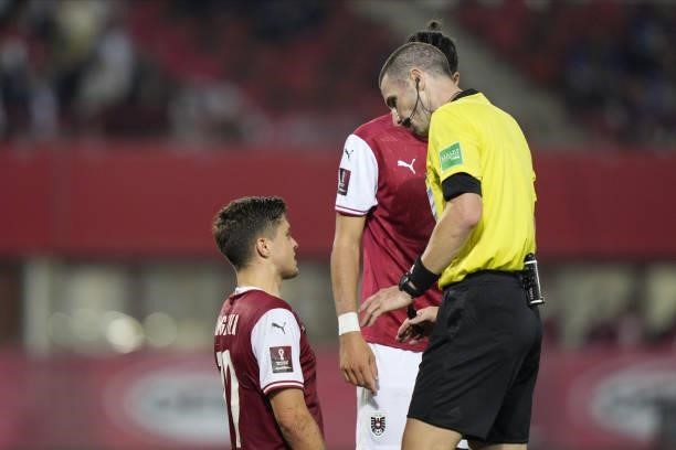 Christoph Baumgartner of Austria and referee Georgi Kabakov of Bulgaria during the 2022 FIFA World Cup Qualifier match between Austria and Scotland...