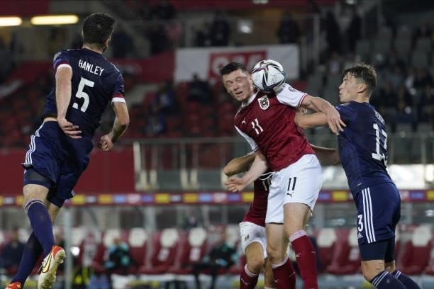 Grant Hanley of Scotland, Michael Gregoritsch of Austria and Lewis Ferguson of Scotland during the 2022 FIFA World Cup Qualifier match between...