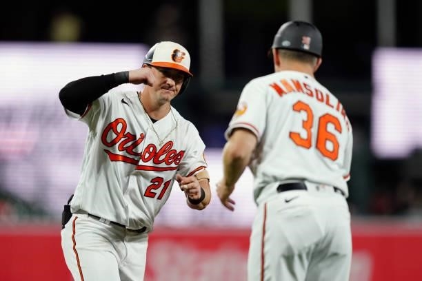 Austin Hays of the Baltimore Orioles is congratulated by Third Base Coach Tony Mansolino after hitting a two run home run in the bottom of the third...