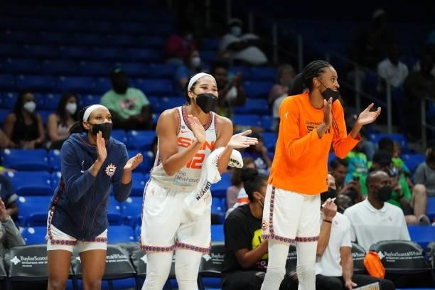 Jasmine Thomas, Brionna Jones and DeWanna Bonner of the Connecticut Sun cheer from the bench during the game against the Dallas Wings on September 7,...