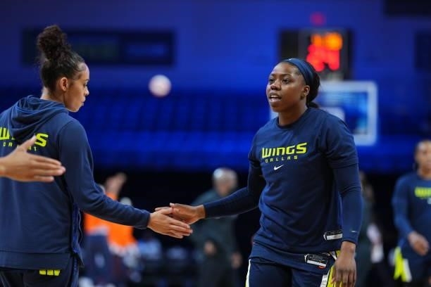 Arike Ogunbowale of the Dallas Wings high-fives teammate Chelsea Dungee before the game against the Connecticut Sun on September 7, 2021 at College...
