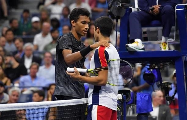 Canada's Felix Auger-Aliassime speaks with Spain's Carlos Alcaraz after Alcaraz retired from the match conceding the win to Auger-Aliassime at the...