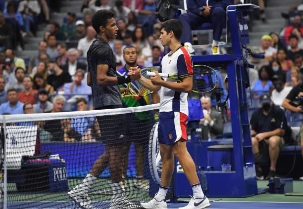 Canada's Felix Auger-Aliassime and Spain's Carlos Alcaraz shake hands after Alcaraz retired from the match conceding the win to Auger-Aliassime at...