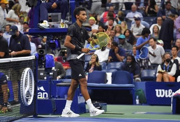Canada's Felix Auger-Aliassime gestures after Spain's Carlos Alcaraz retired from the match conceding the win to Auger-Aliassime at the 2021 US Open...
