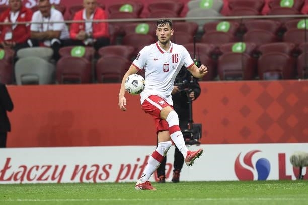 Jakub Moder of Poland passes the ball during 2022 FIFA World Cup Qualifier match between Poland and England at Stadion Narodowy on September 8, 2021...