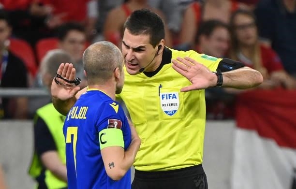 Slovenian referee Rade Obrenovic and Andorra's captain midfielder Marc Pujol react during the FIFA World Cup Qatar 2022 qualification Group I...
