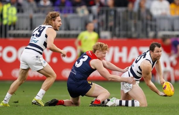 Patrick Dangerfield of the Cats is tackled by Clayton Oliver of the Demons during the 2021 AFL First Preliminary Final match between the Melbourne...
