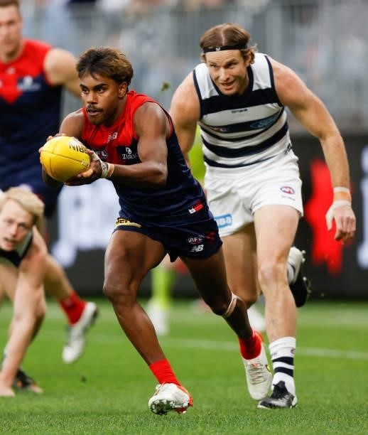 Kysaiah Pickett of the Demons is chased by Lachie Henderson of the Cats during the 2021 AFL First Preliminary Final match between the Melbourne...