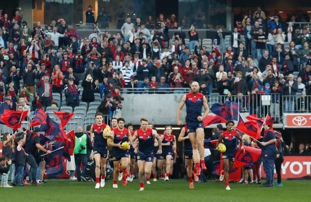 The Demons run onto the field during the 2021 AFL First Preliminary Final match between the Melbourne Demons and the Geelong Cats at Optus Stadium on...