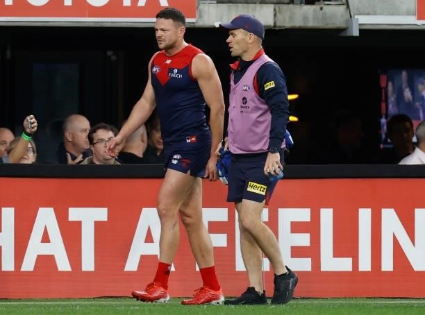 Steven May of the Demons leaves the ground with an injury during the 2021 AFL First Preliminary Final match between the Melbourne Demons and the...