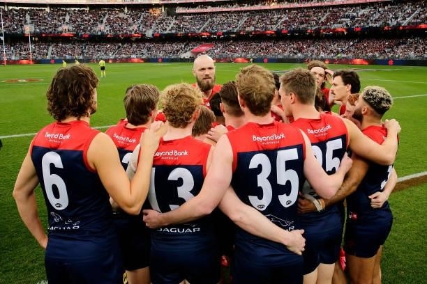 Max Gawn of the Demons speaks to the huddle at the start of the game during the 2021 AFL First Preliminary Final match between the Melbourne Demons...